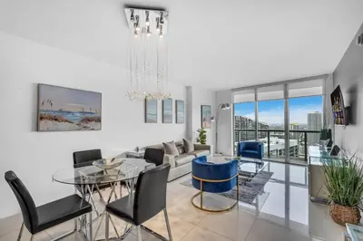 a living room with a glass table and chairs at Lovely 1BR W Icon Brickell-FREE SPA in Miami