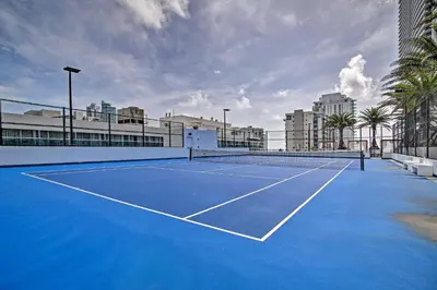 a tennis court with blue paint on it at Walk to Hollywood Beach Upscale 16th-Floor Condo in Hollywood