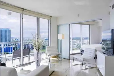 a living room with white furniture and large windows at Beautiful apartment Miami, FL in Miami