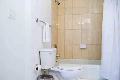 a bathroom with a white toilet and a shower at Beautiful apartment Miami, FL in Miami