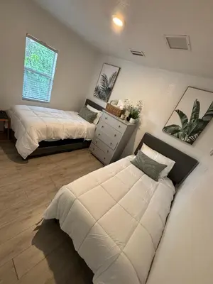 a bedroom with two beds and a window at Deluxe Room in best location Miami in a 2 Bedrooms Unit - Parking, Laundry and Luggage Storage in Miami