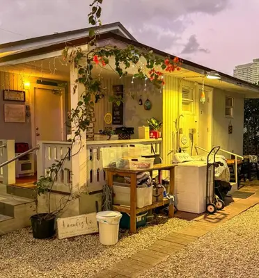a small yellow house with a table in front of it at House 2 Bedrooms plus CouchBed Best Location MIami Private Parking, Laundry, Storage for Luggage in Miami