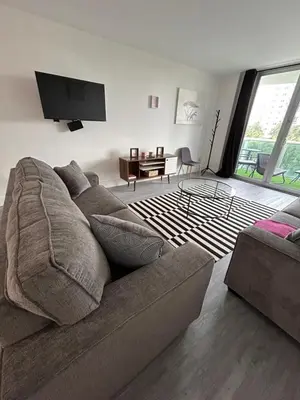 a living room with a couch and a flat screen tv at #310 Sunny Isles Ocean Reserve with FREE Parking include in Sunny Isles Beach