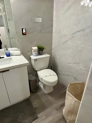 a bathroom with a white toilet and a sink at #310 Sunny Isles Ocean Reserve with FREE Parking include in Sunny Isles Beach