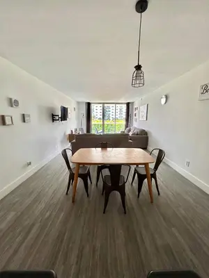 a living room with a table and a couch at #310 Sunny Isles Ocean Reserve with FREE Parking include in Sunny Isles Beach