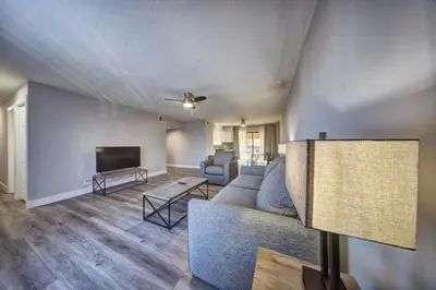 a living room with a couch and a tv at Mahalo Isles Apartments by Rocketstay in Fort Lauderdale
