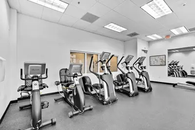 a gym with a row of cardio bikes and treadmills at Lovely Studio in brickell -2 beds and Free parking in Miami