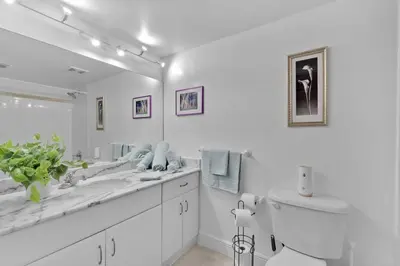 a white bathroom with a sink and a toilet at Lovely Studio in brickell -2 beds and Free parking in Miami