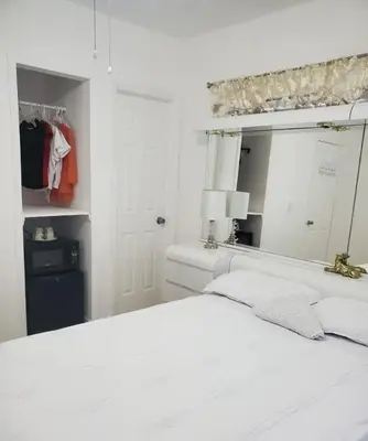 a white bedroom with a white bed and a mirror at B1 Best Value on Private Bedroom with Private Bathroom in Little Havana, Miami in Miami