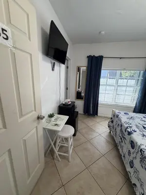 a bedroom with a bed and a table and a door at B5 Best Value on Private Bedroom with Private Bathroom in Little Havana, Miami in Miami