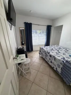 a bedroom with a bed and a table and a window at B5 Best Value on Private Bedroom with Private Bathroom in Little Havana, Miami in Miami