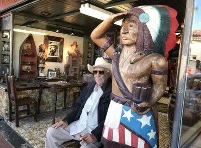 a man sitting next to a statue in a store at B6 Best Value on Private Bedroom with Private Bathroom in Little Havana, Miami in Miami
