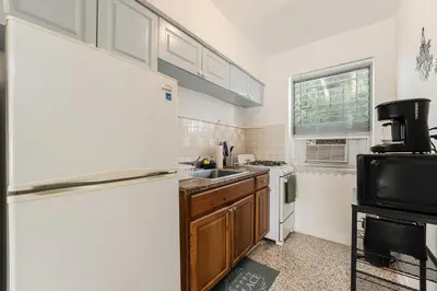 a kitchen with a refrigerator and a sink at Vibrant Little Havana Apt with Parking in Miami