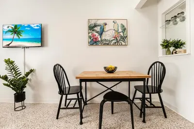a dining room with a table and two chairs at Vibrant Little Havana Apt with Parking in Miami