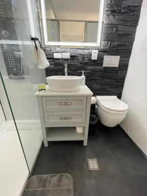 a bathroom with a sink and a toilet and a mirror at Unique Houseboat Modern and New in Fort Lauderdale