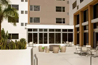 a courtyard with tables and chairs in a building at Element Miami Doral in Miami