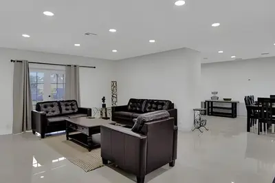a living room with two couches and a table at Luxury Miami Villa in North Miami