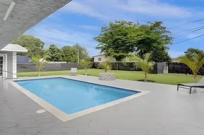 a swimming pool in the backyard of a house at Luxury Miami Villa in North Miami