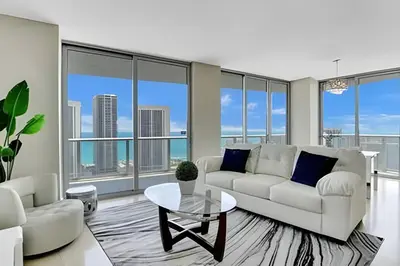 a living room with a white couch and a table at Million Dollar Penthouse with Pool Amazing Views in Hallandale Beach