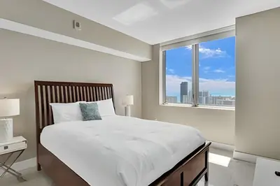 a white bedroom with a large bed and a window at Million Dollar Penthouse with Pool Amazing Views in Hallandale Beach