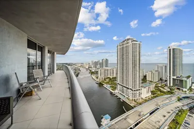 a balcony with a view of a river and buildings at Million Dollar Waterfront Penthouse in Hallandale Beach