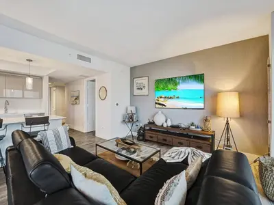 a living room with a couch and a table at Luxury Waterfront Suite with Great Views in Hallandale Beach
