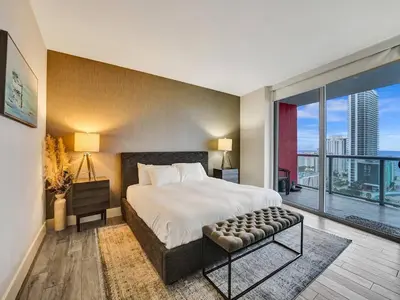 a bedroom with a large bed and a large window at Luxury Waterfront Suite with Great Views in Hallandale Beach