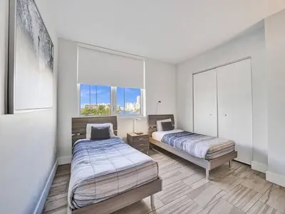 a bedroom with two beds and a window at Luxury Waterfront Suite in Hallandale Beach