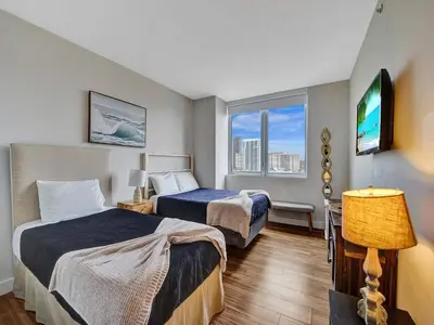 a hotel room with two beds and a window at Luxury Waterfront Condo in Hallandale Beach