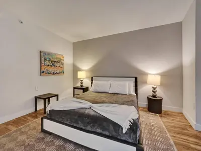 a bedroom with a large bed and two lamps at Luxury Waterfront Condo in Hallandale Beach