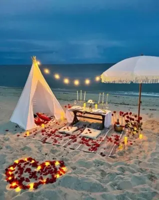a tent on the beach with a table and candles at Luxury Waterfront Condo in Hallandale Beach