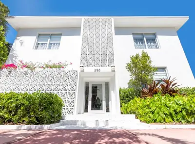a white house with bushes in front of it at Kasa Collins Park Miami Beach Convention Center in Miami Beach