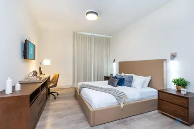 a hotel room with a bed and a desk and a room at Hollywood Bliss Studio Balcony Beach View in Hollywood