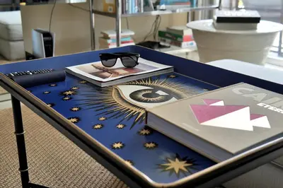a table with a book and glasses on top of it at Dolce Vita Hideaway Pool House by Pako Stays in Miami