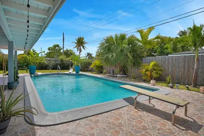 a swimming pool with a bench in a yard at Dolce Vita Hideaway Pool House by Pako Stays in Miami