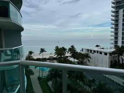 a view of the beach from the balcony of a building at 7th FL Ocean view spacious 1 bedroom in Hollywood