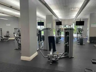 a gym with several rows of treadmills and machines at 7th FL Ocean view spacious 1 bedroom in Hollywood