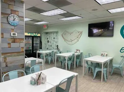 a dining room with tables and chairs in a restaurant at 7th FL Ocean view spacious 1 bedroom in Hollywood