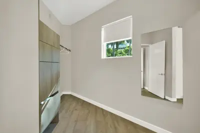 a hallway with white walls and a window at Stunning Home LifeStyle Miami in Miami