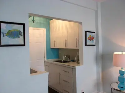 a kitchen with a sink and a mirror at Lux Condo by the Beach in Miami Beach