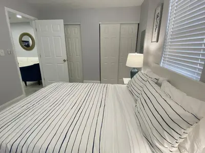 a white bed in a bedroom with a window at Annas Peaceful mini Luxury suite in Fort Lauderdale