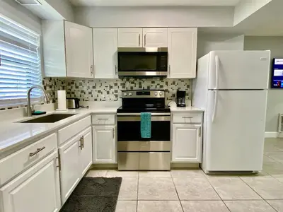 a kitchen with white cabinets and a white refrigerator at Anna's peaceful Getaway Luxury Suite in Fort Lauderdale