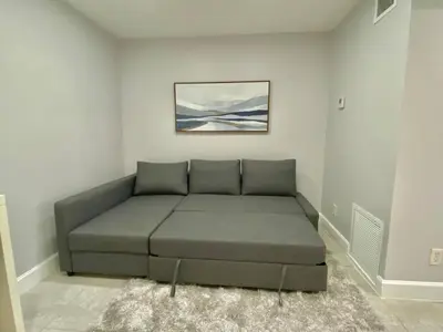 a couch in a living room with a painting on the wall at Anna's peaceful Getaway Luxury Suite in Fort Lauderdale
