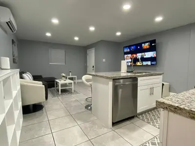 a kitchen with a bar and a living room at Executive Luxury Suite in Fort Lauderdale
