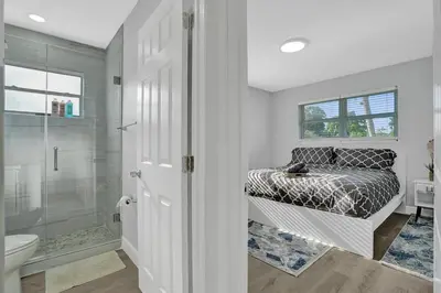 a bathroom with a bed and a shower at The Front Wave Luxury Home in Fort Lauderdale