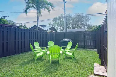 a group of green chairs and a table in a yard at Luxury home in Fort Lauderdale