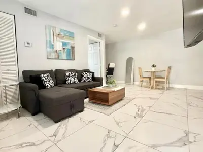 a living room with a couch and a table at Mazor luxury one bedroom vacation Home in Fort Lauderdale