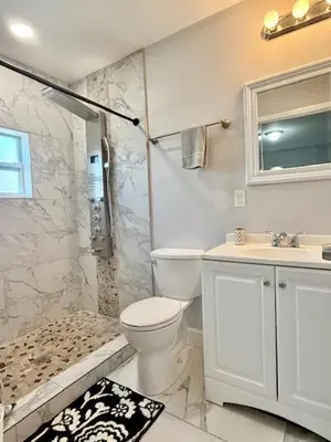a bathroom with a toilet and a shower and a sink at Mazor luxury one bedroom vacation Home in Fort Lauderdale