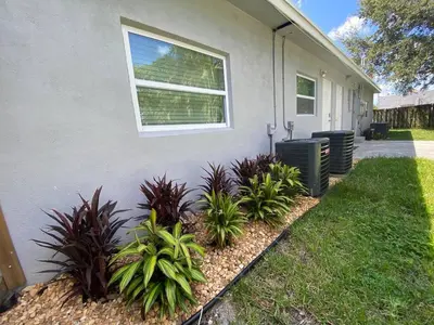 a house with plants on the side of it at Mazor luxury one bedroom vacation Home in Fort Lauderdale