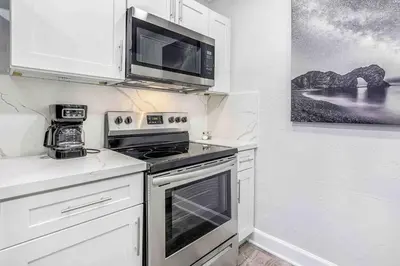 a kitchen with a stove and a microwave at Mazor Luxury Two bedroom vacation Home in Fort Lauderdale